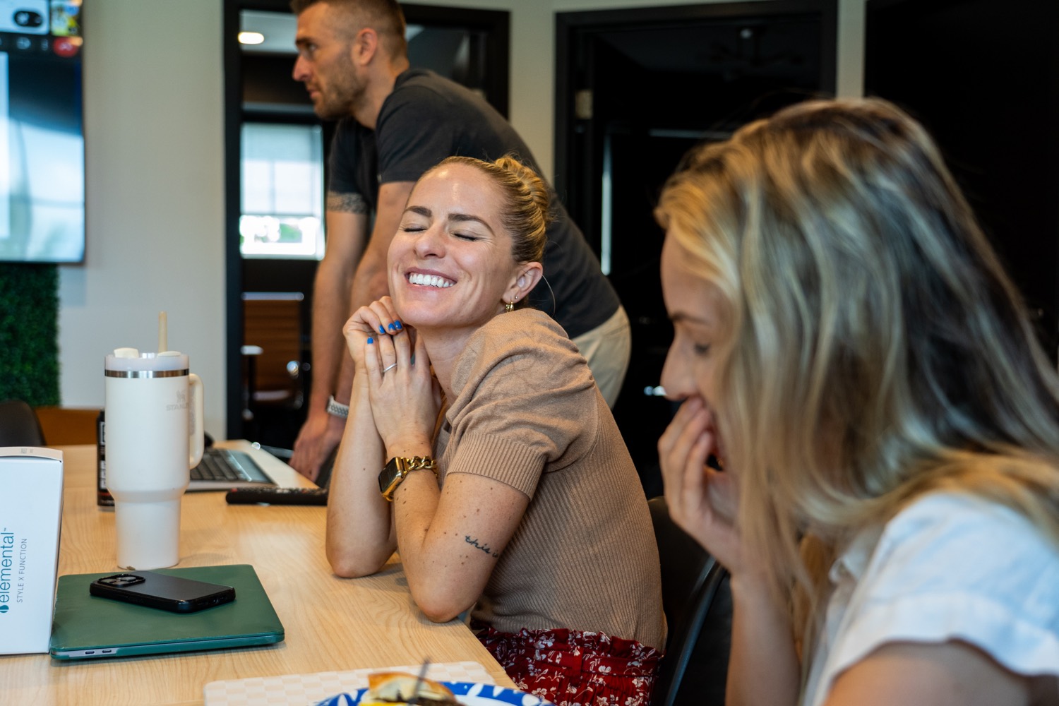 Team members laughing together at the office