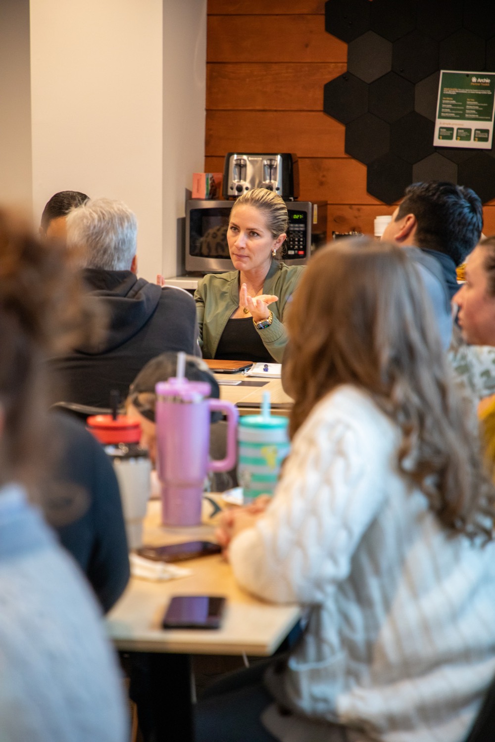 A leader coaching the team during a meeting